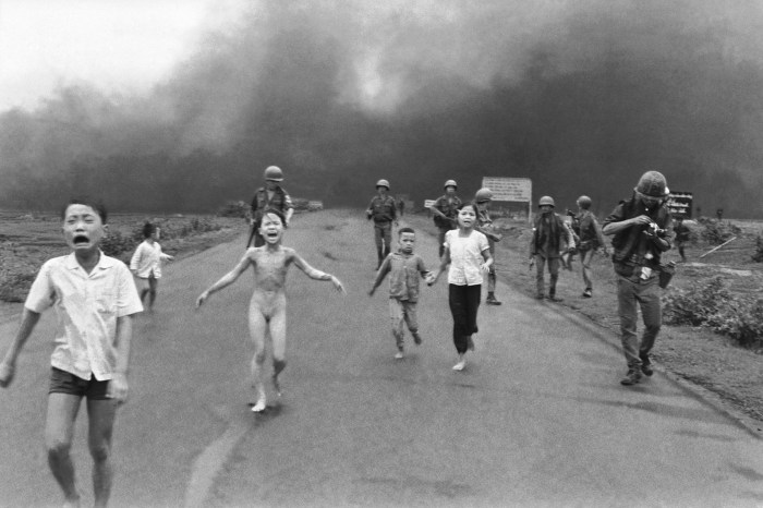 South Vietnamese forces follow after terrified children, including 9-year-old Kim Phuc, center, as they run down Route 1 near Trang Bang after an aerial napalm attack on suspected Viet Cong hiding places, June 8, 1972. A South Vietnamese plane accidentally dropped its flaming napalm on South Vietnamese troops and civilians. The terrified girl had ripped off her burning clothes while fleeing. The children from left to right are: Phan Thanh Tam, younger brother of Kim Phuc, who lost an eye, Phan Thanh Phouc, youngest brother of Kim Phuc, Kim Phuc, and Kim's cousins Ho Van Bon, and Ho Thi Ting. Behind them are soldiers of the Vietnam Army 25th Division. (AP Photo/Nick Ut)